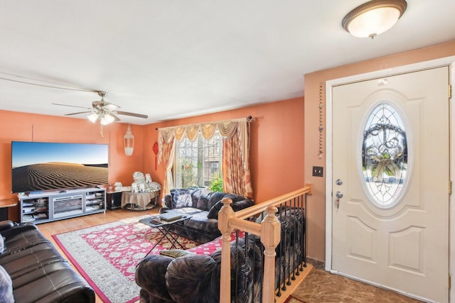 foyer entrance featuring wood finished floors and ceiling fan