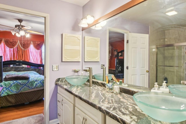 bathroom featuring a sink, connected bathroom, and a stall shower