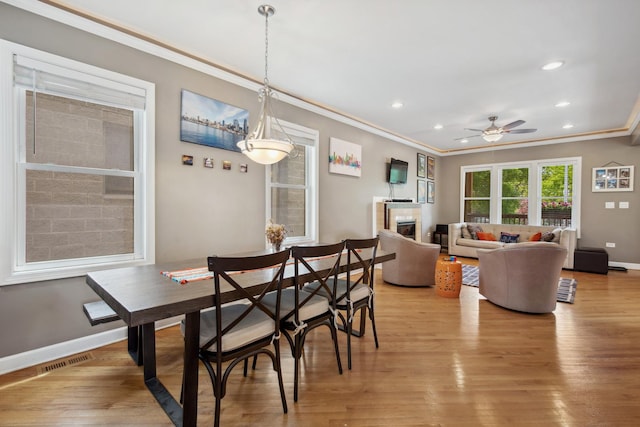 6029 N Ridge Ave, Chicago, IL 60660 - dining room featuring ornamental molding, recessed lighting, light wood-style flooring, ceiling fan, and a glass covered fireplace