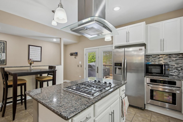 6029 N Ridge Ave, Chicago, IL 60660 - kitchen with stainless steel appliances, island exhaust hood, light tile patterned floors, white cabinets, and recessed lighting