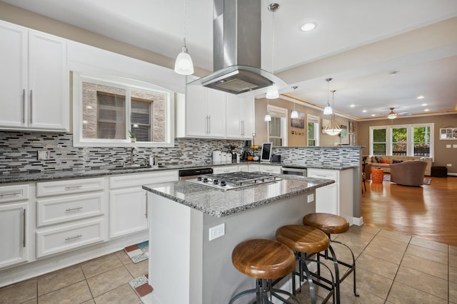 6029 N Ridge Ave, Chicago, IL 60660 - kitchen featuring a sink, light tile patterned flooring, island exhaust hood, stainless steel gas stovetop, and recessed lighting