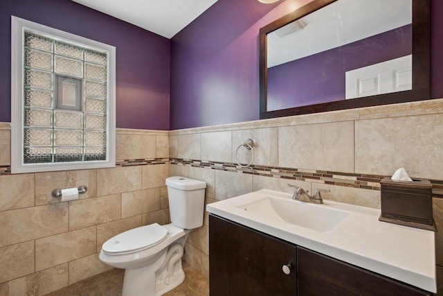 6029 N Ridge Ave, Chicago, IL 60660 - half bath featuring toilet, vanity, healthy amount of natural light, tile walls, and tile patterned flooring
