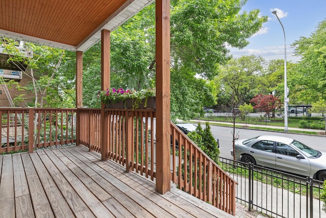 6029 N Ridge Ave, Chicago, IL 60660 - wooden porch featuring view of scattered trees
