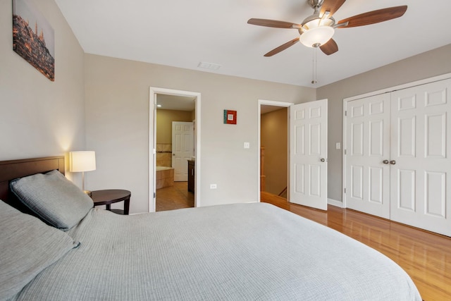 6029 N Ridge Ave, Chicago, IL 60660 - bedroom with wood finished floors, a closet, baseboards, ceiling fan, and ensuite bathroom