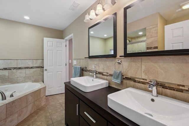 6029 N Ridge Ave, Chicago, IL 60660 - bathroom with double vanity, a bath, tile patterned flooring, tile walls, and a shower