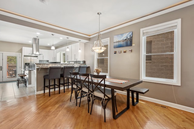 6029 N Ridge Ave, Chicago, IL 60660 - dining space featuring crown molding, light wood-type flooring, baseboards, and recessed lighting