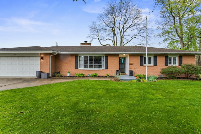1003 Poplar St, Monticello, IL 61856 - ranch-style home featuring brick siding, an attached garage, a front yard, and concrete driveway