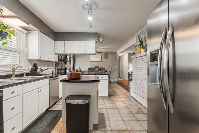 1003 Poplar St, Monticello, IL 61856 - kitchen with appliances with stainless steel finishes, a sink, white cabinetry, and dark countertops