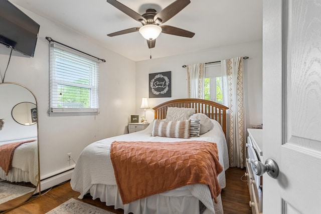 1003 Poplar St, Monticello, IL 61856 - bedroom featuring a baseboard heating unit, wood finished floors, and a ceiling fan