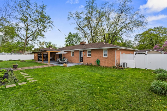 1003 Poplar St, Monticello, IL 61856 - back of property with brick siding, a patio area, a gate, a chimney, and central air condition unit