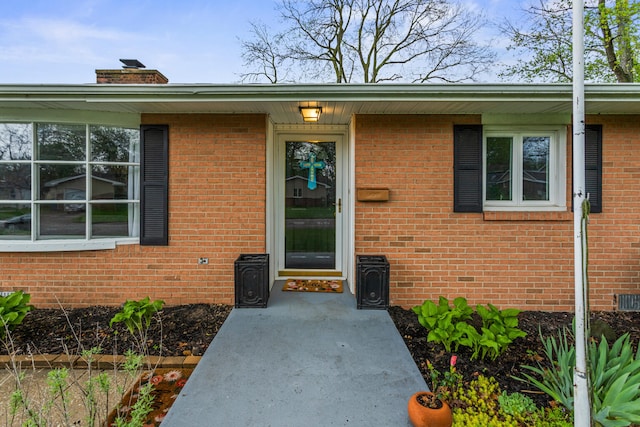 1003 Poplar St, Monticello, IL 61856 - property entrance with brick siding and a chimney
