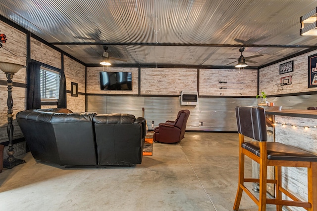 1003 Poplar St, Monticello, IL 61856 - cinema room featuring concrete floors, a ceiling fan, and heating unit