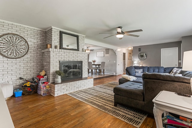 1003 Poplar St, Monticello, IL 61856 - living area with ceiling fan, wood finished floors, and a fireplace