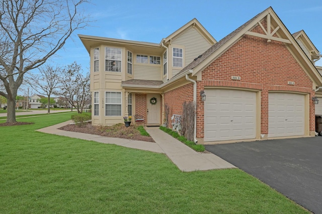 1601 Penny Ln Unit B, Crystal Lake, IL 60014 - traditional-style house featuring brick siding, aphalt driveway, a front yard, and a garage
