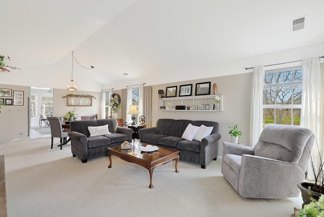 1601 Penny Ln Unit B, Crystal Lake, IL 60014 - living room featuring plenty of natural light, visible vents, lofted ceiling, and light carpet