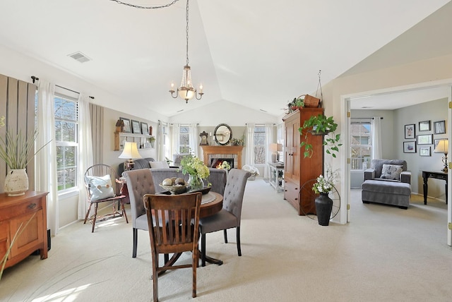 1601 Penny Ln Unit B, Crystal Lake, IL 60014 - dining area featuring lofted ceiling, visible vents, an inviting chandelier, and light colored carpet