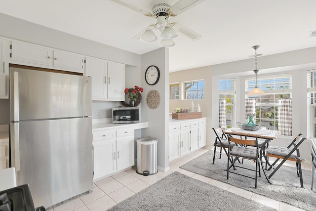 1601 Penny Ln Unit B, Crystal Lake, IL 60014 - kitchen featuring white cabinets, light countertops, light tile patterned flooring, appliances with stainless steel finishes, and ceiling fan