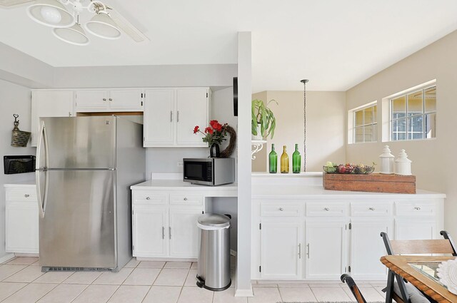 1601 Penny Ln Unit B, Crystal Lake, IL 60014 - kitchen with white cabinets, stainless steel appliances, an inviting chandelier, light countertops, and light tile patterned floors
