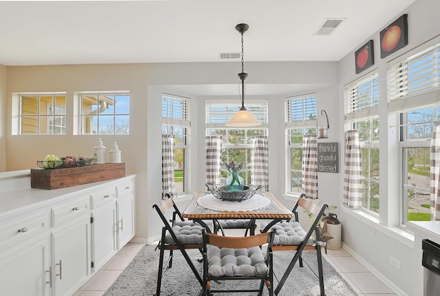 1601 Penny Ln Unit B, Crystal Lake, IL 60014 - dining area with light tile patterned flooring, baseboards, visible vents, and a healthy amount of sunlight