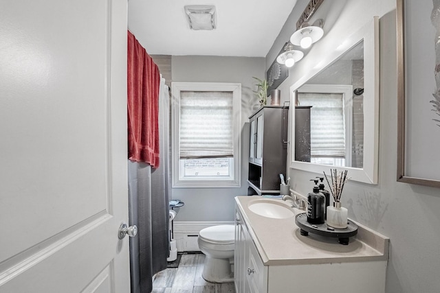 4158 W Nelson St, Chicago, IL 60641 - bathroom featuring a baseboard heating unit, toilet, and vanity