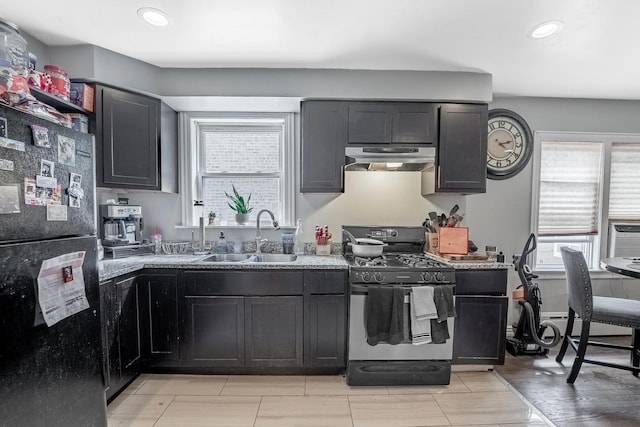 4158 W Nelson St, Chicago, IL 60641 - kitchen with recessed lighting, under cabinet range hood, a sink, light stone countertops, and black appliances