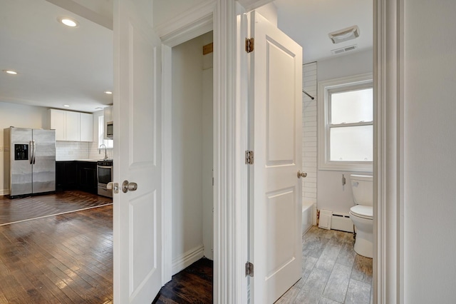 4158 W Nelson St, Chicago, IL 60641 - hallway with a baseboard heating unit, baseboards, visible vents, recessed lighting, and hardwood / wood-style flooring