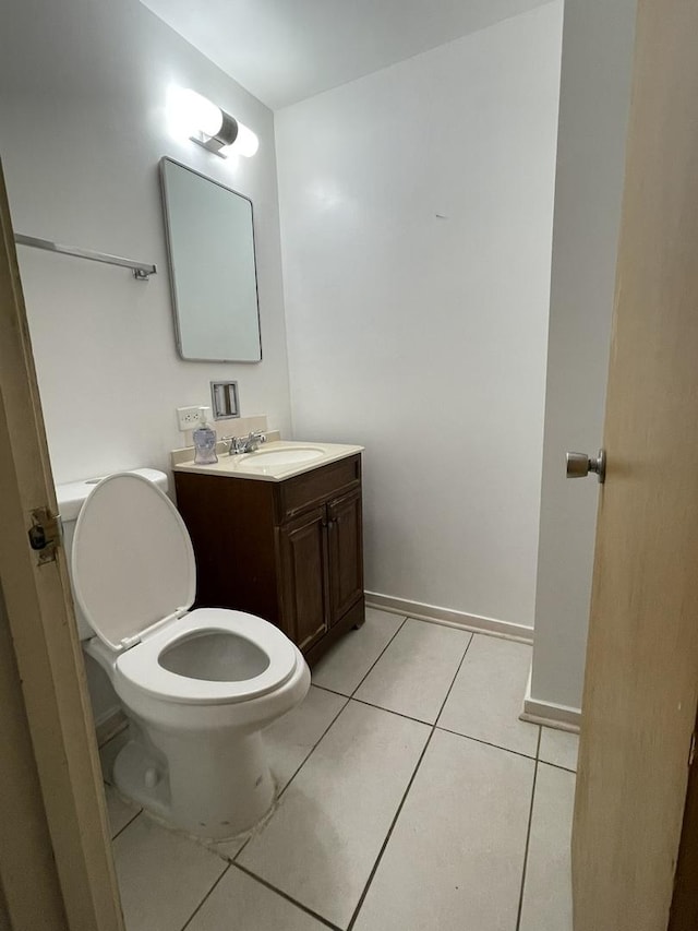 5517 S Dorchester Ave, Chicago, IL 60637 - half bath with vanity, toilet, tile patterned flooring, and baseboards