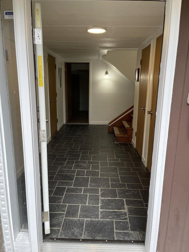 5517 S Dorchester Ave, Chicago, IL 60637 - hallway with brick patterned flooring, stairs, and baseboards