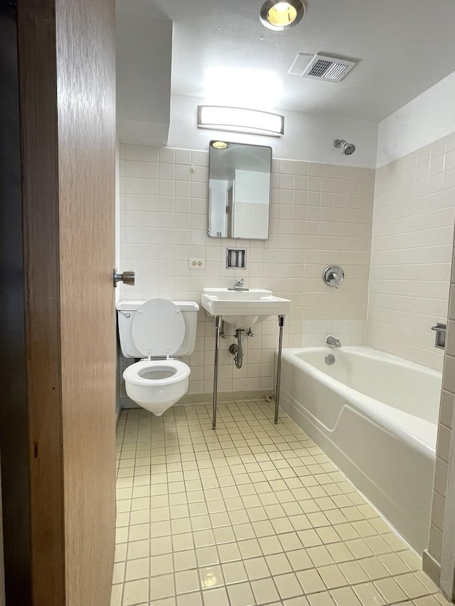 5517 S Dorchester Ave, Chicago, IL 60637 - bathroom featuring toilet,  shower combination, tile patterned floors, and a sink