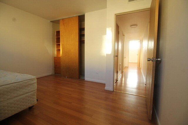 5517 S Dorchester Ave, Chicago, IL 60637 - bedroom with wood finished floors, baseboards, and a closet