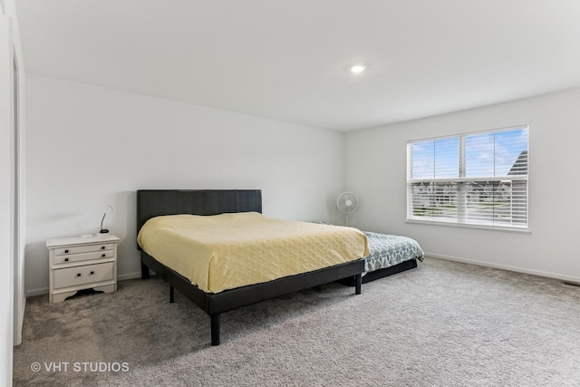 carpeted bedroom featuring baseboards and recessed lighting