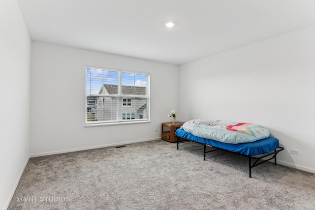 carpeted bedroom featuring visible vents and baseboards