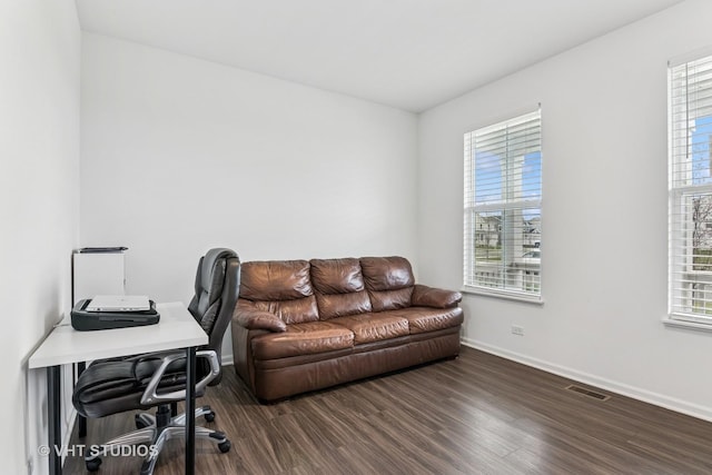 home office featuring baseboards, wood finished floors, and visible vents