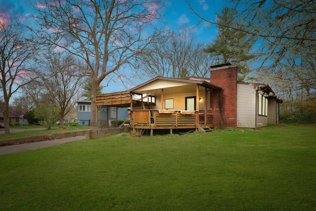 302 Flora Dr, Champaign, IL 61821 - rear view of house featuring a lawn, a deck, a chimney, and a detached carport
