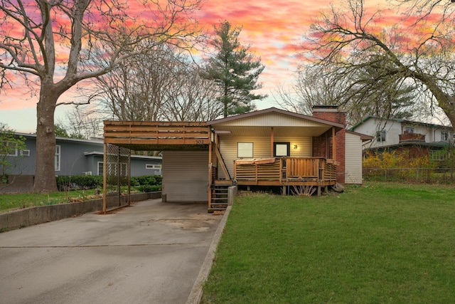 302 Flora Dr, Champaign, IL 61821 - view of front facade featuring concrete driveway, a chimney, an attached carport, and a deck
