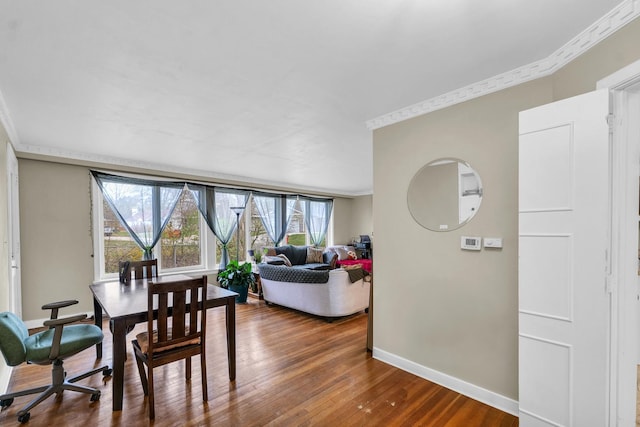 302 Flora Dr, Champaign, IL 61821 - dining space featuring ornamental molding, wood finished floors, and baseboards