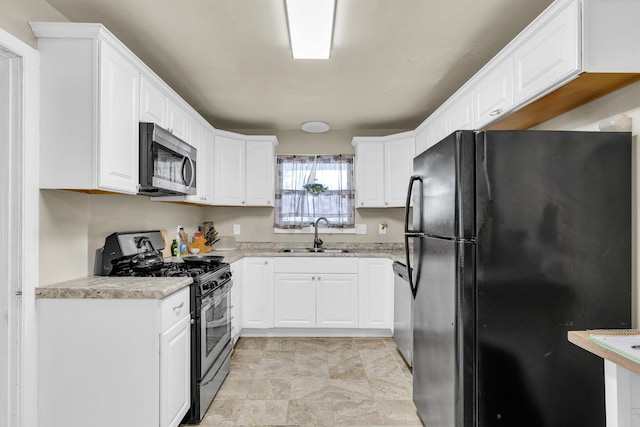 302 Flora Dr, Champaign, IL 61821 - kitchen with appliances with stainless steel finishes, a sink, light countertops, and white cabinets