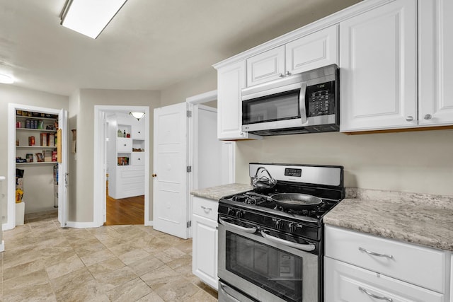 302 Flora Dr, Champaign, IL 61821 - kitchen with appliances with stainless steel finishes, white cabinetry, and baseboards