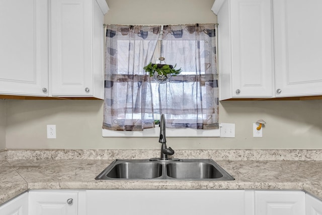 302 Flora Dr, Champaign, IL 61821 - kitchen featuring a sink, white cabinetry, and light countertops