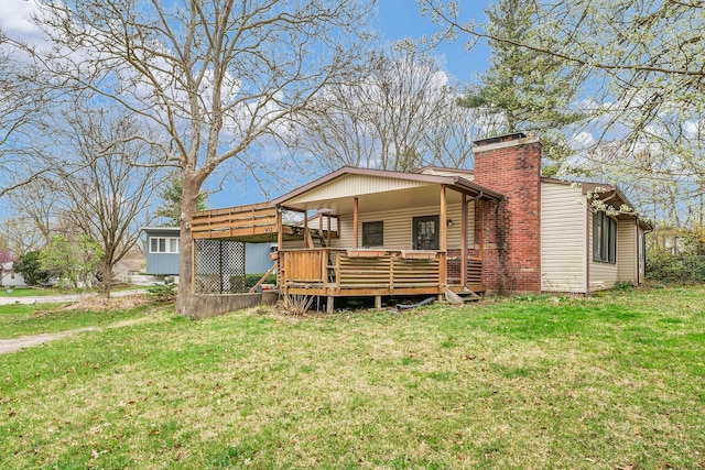 302 Flora Dr, Champaign, IL 61821 - view of front of home featuring a front lawn, a wooden deck, and a chimney