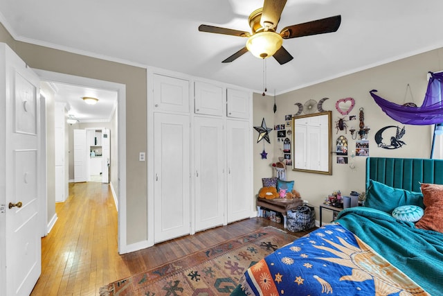 302 Flora Dr, Champaign, IL 61821 - bedroom with light wood-style flooring, a closet, crown molding, a ceiling fan, and baseboards