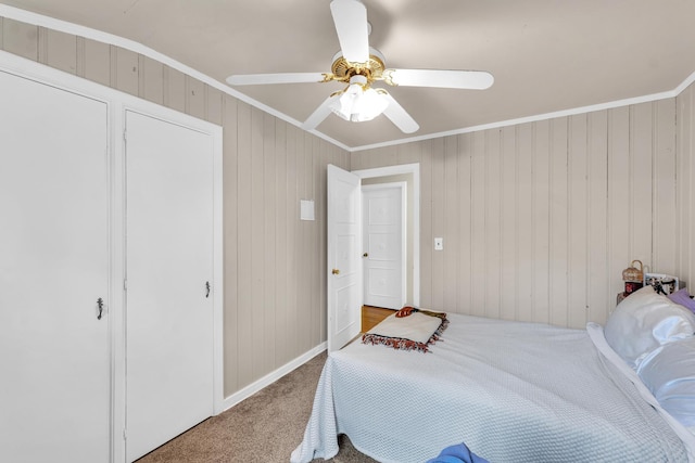 302 Flora Dr, Champaign, IL 61821 - carpeted bedroom featuring crown molding, ceiling fan, baseboards, and wood walls