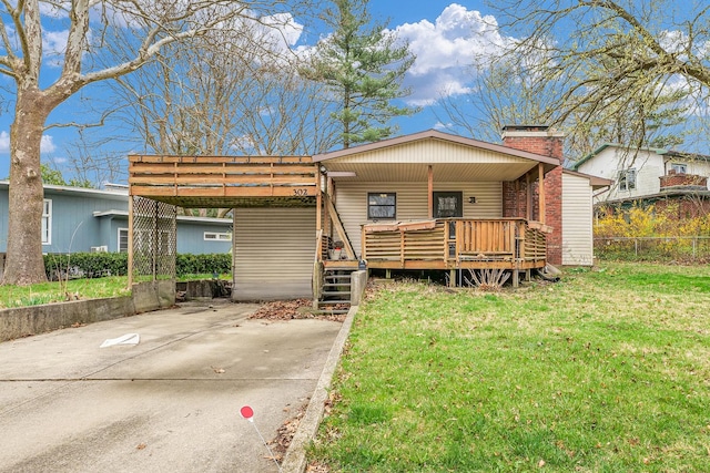 302 Flora Dr, Champaign, IL 61821 - view of front of house featuring an attached carport, a chimney, a deck, and brick siding