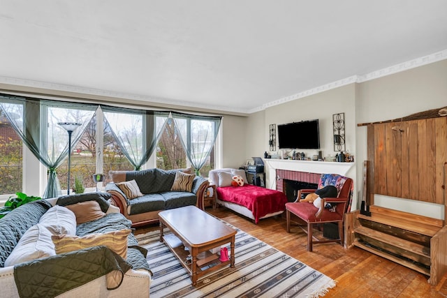 302 Flora Dr, Champaign, IL 61821 - living area featuring hardwood / wood-style floors, a fireplace, and crown molding
