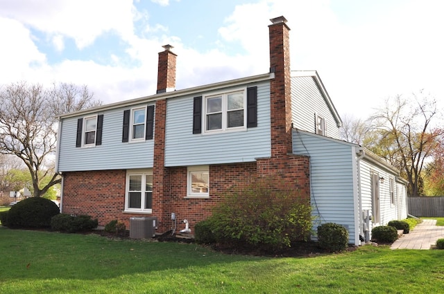 37 Pottowattomie Ct, Naperville, IL 60563 - view of property exterior featuring a chimney, central AC unit, a yard, and brick siding
