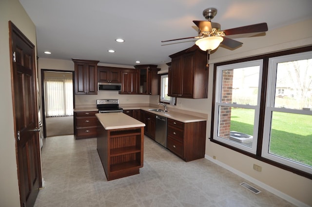 37 Pottowattomie Ct, Naperville, IL 60563 - kitchen featuring appliances with stainless steel finishes, a sink, ceiling fan, light countertops, and a center island