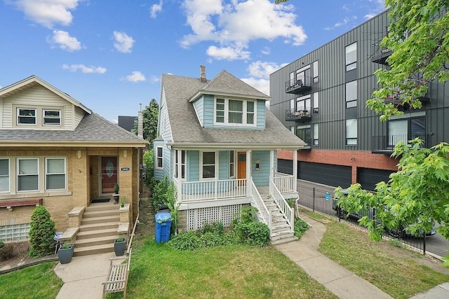3945 W Dakin St, Chicago, IL 60618 - view of front of property with stairway, covered porch, a shingled roof, and a front lawn