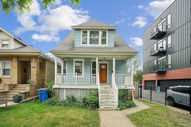 3945 W Dakin St, Chicago, IL 60618 - bungalow featuring covered porch, stairs, a shingled roof, and a garage