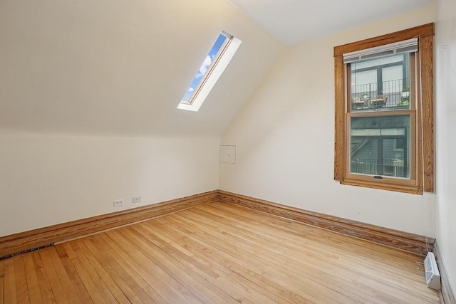 3945 W Dakin St, Chicago, IL 60618 - additional living space featuring a skylight, vaulted ceiling, and hardwood / wood-style flooring