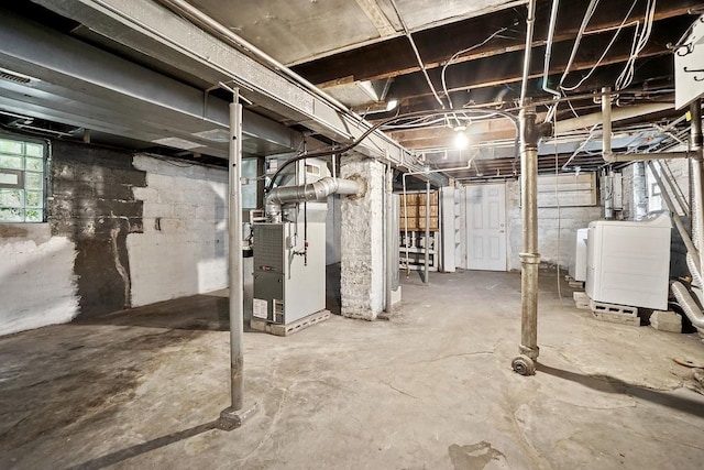 3945 W Dakin St, Chicago, IL 60618 - below grade area featuring heating unit and washer and clothes dryer